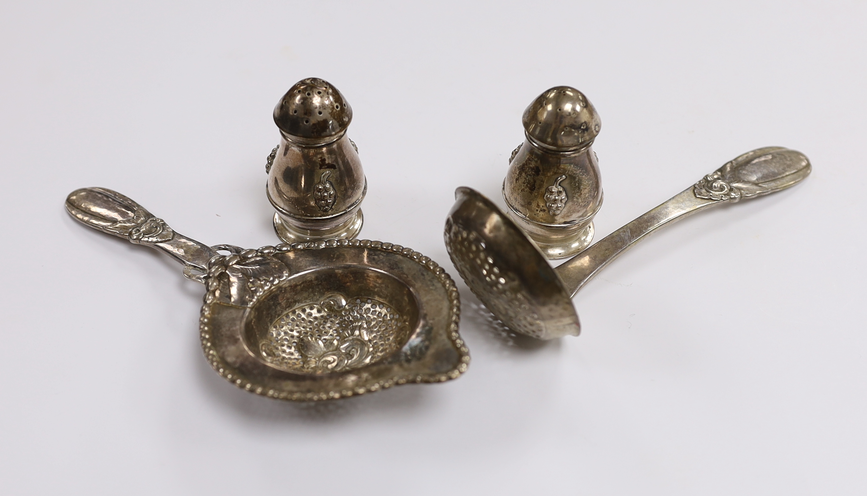 A Danish 830 white metal sifter spoon and tea strainer, by Evald Nielsen and a pair of 1930's Danish white metal condiments.